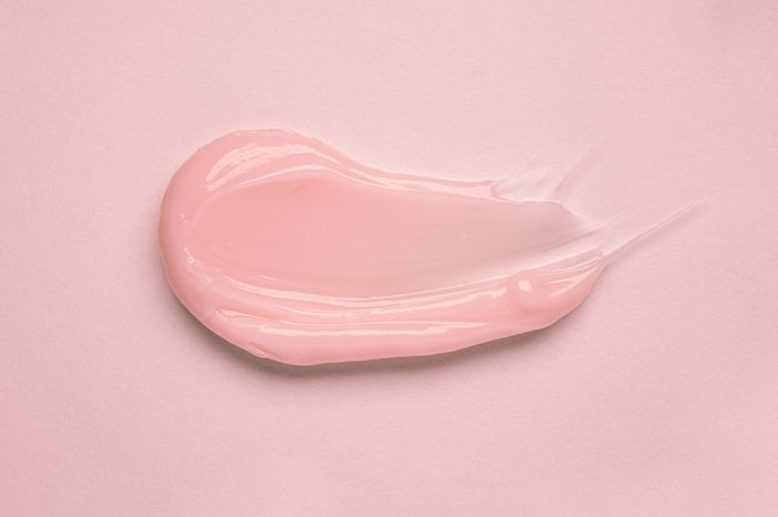 Cosmetic products creamy pink texture smudge nude background