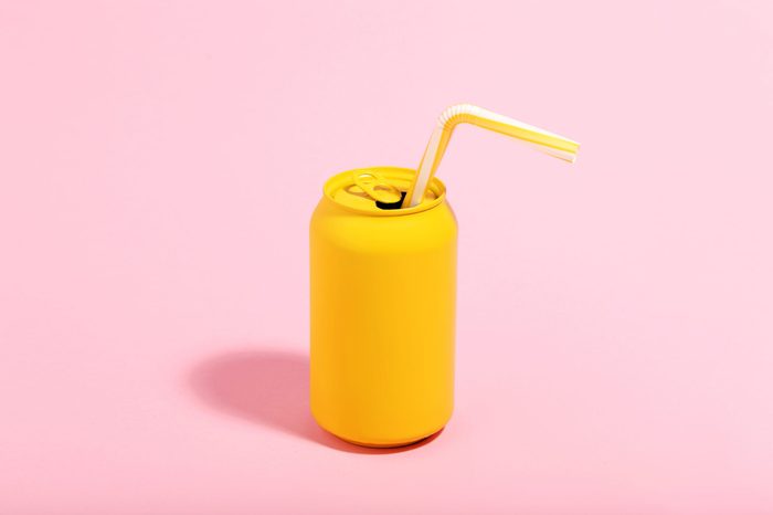 Aluminum can with straw on pink background. Minimalism concept