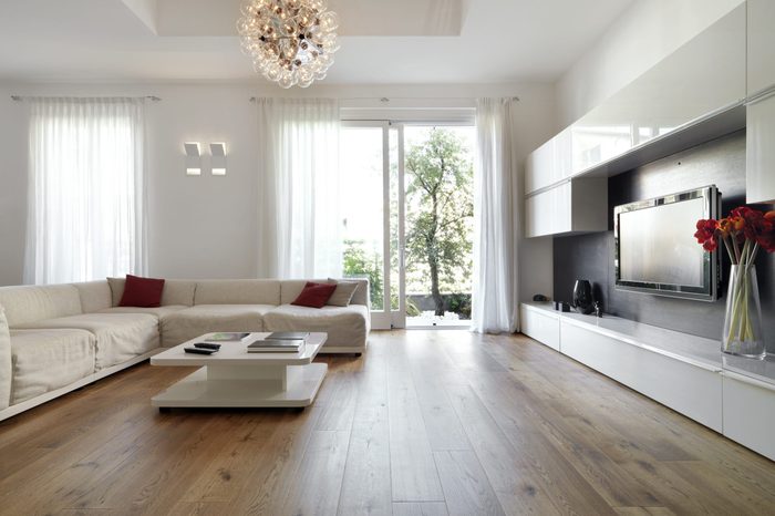 internal view of a modern living room with wood flooring overlooking on the garden