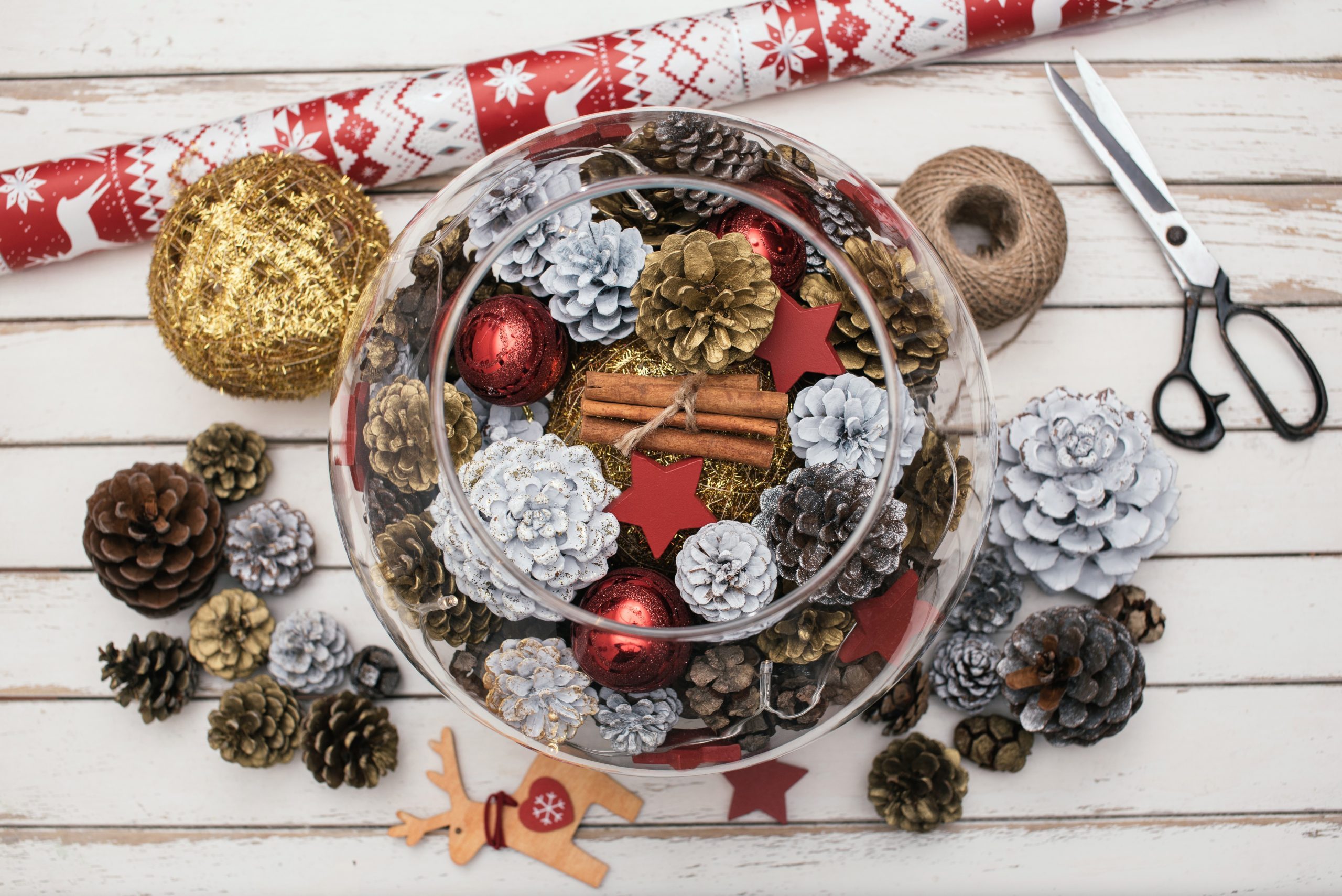 Decorating Christmas table with pine cones 