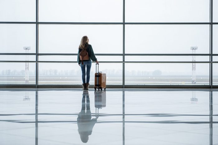 Single girl realizing an old dream. She is traveling with bag to foreign country. Copy space in right side
