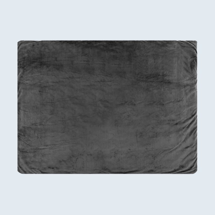 A dark gray blanket lies flat against a light gray background, appearing soft and slightly textured.