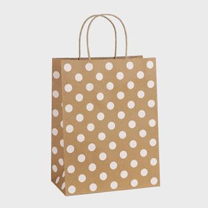 A brown paper bag with white polka dots stands upright against a plain, light background.