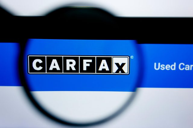 Magnifying glass shows the word "CARFAX" on a blue background with "Used Car" partially visible.
