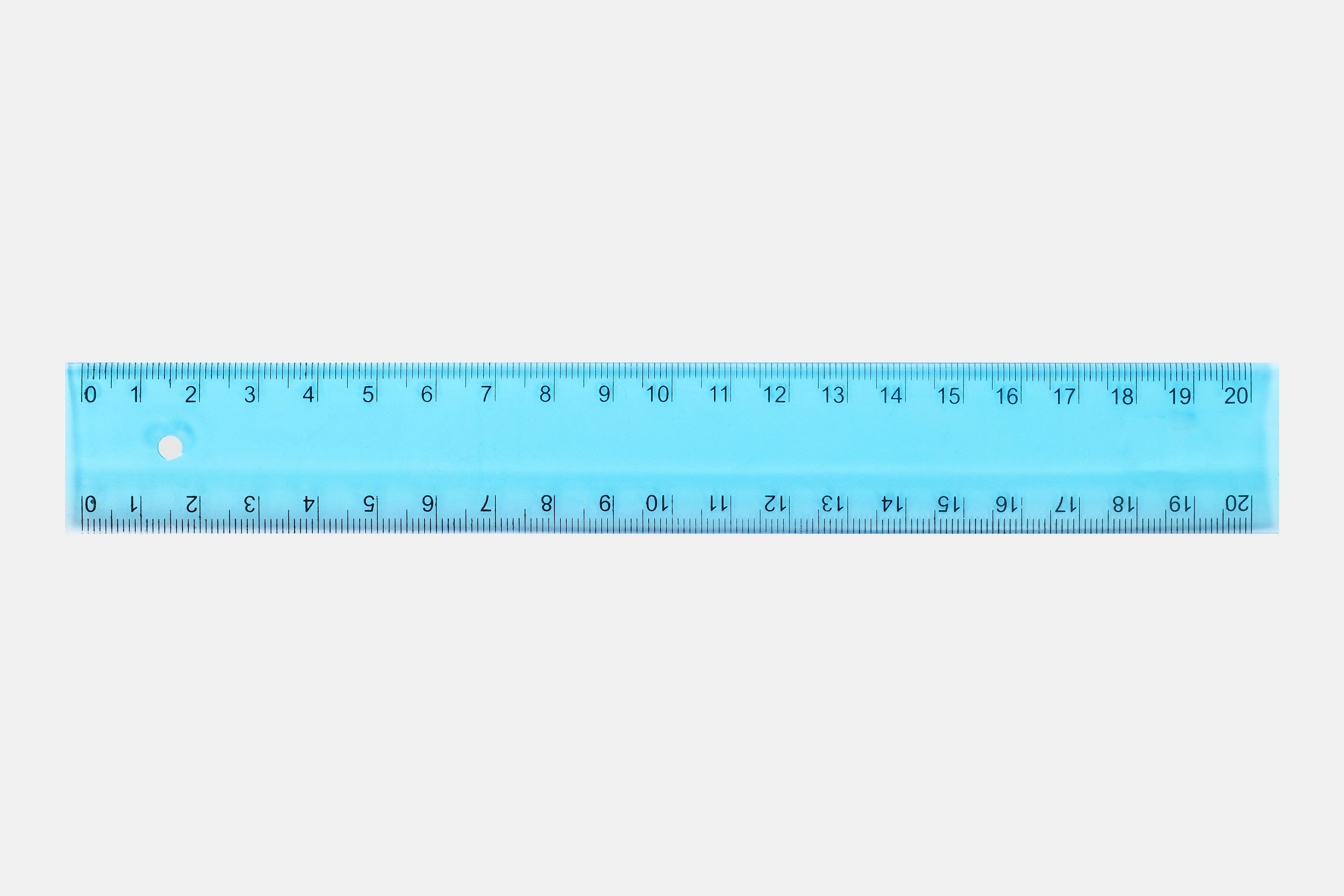 Ruler measuring; transparent blue with numbers 0 to 20; placed on a plain, light gray background.