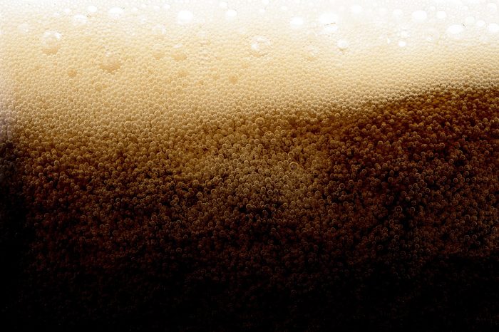 Cola soda splash beverage drink foam bubble in glass texture background