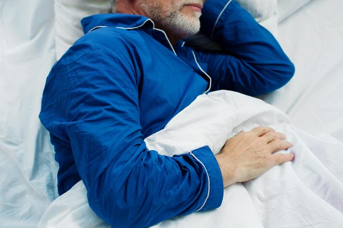 old man sleeping in bed