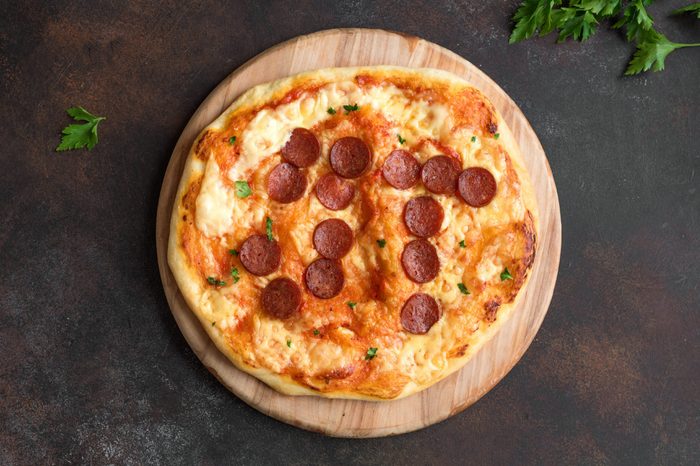 Pi Day Pizza. Homemade Pepperoni and Cheese Pizza for Pi Day Event, top view. Pepperoni positioning forms a pi symbol.