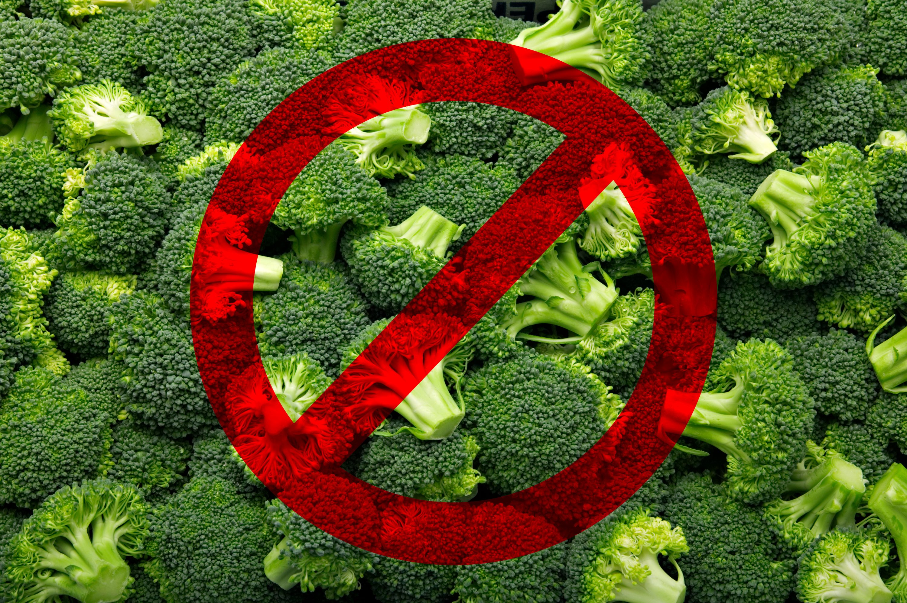 Broccoli covered by a red prohibition symbol, indicating disapproval or restriction, against a backdrop of green broccoli florets.