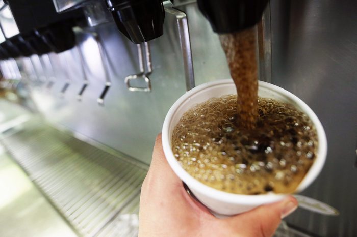 soda fountain close up. coke pouring into a cup.