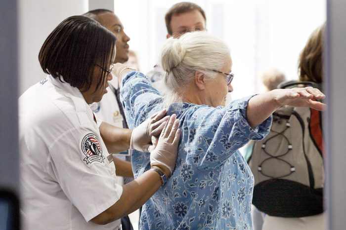 A Transportation Security Administration worker pats down a traveler September 22, 2004 at O'Hare International Airport in Chicago.