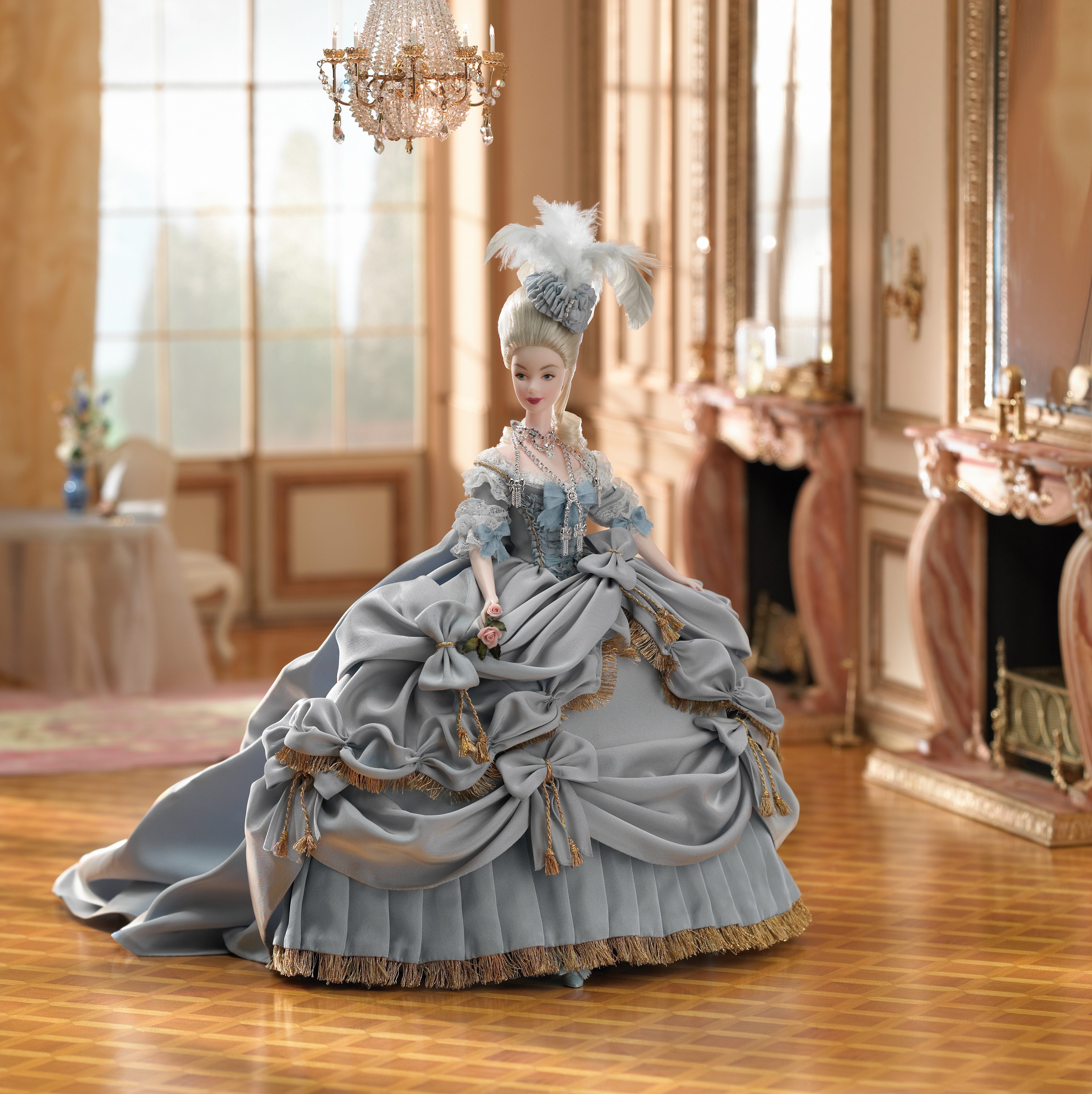 A doll wears an elaborate eighteenth-century gown with feathers, standing elegantly in an opulent, chandelier-lit room adorned with ornate furnishings.