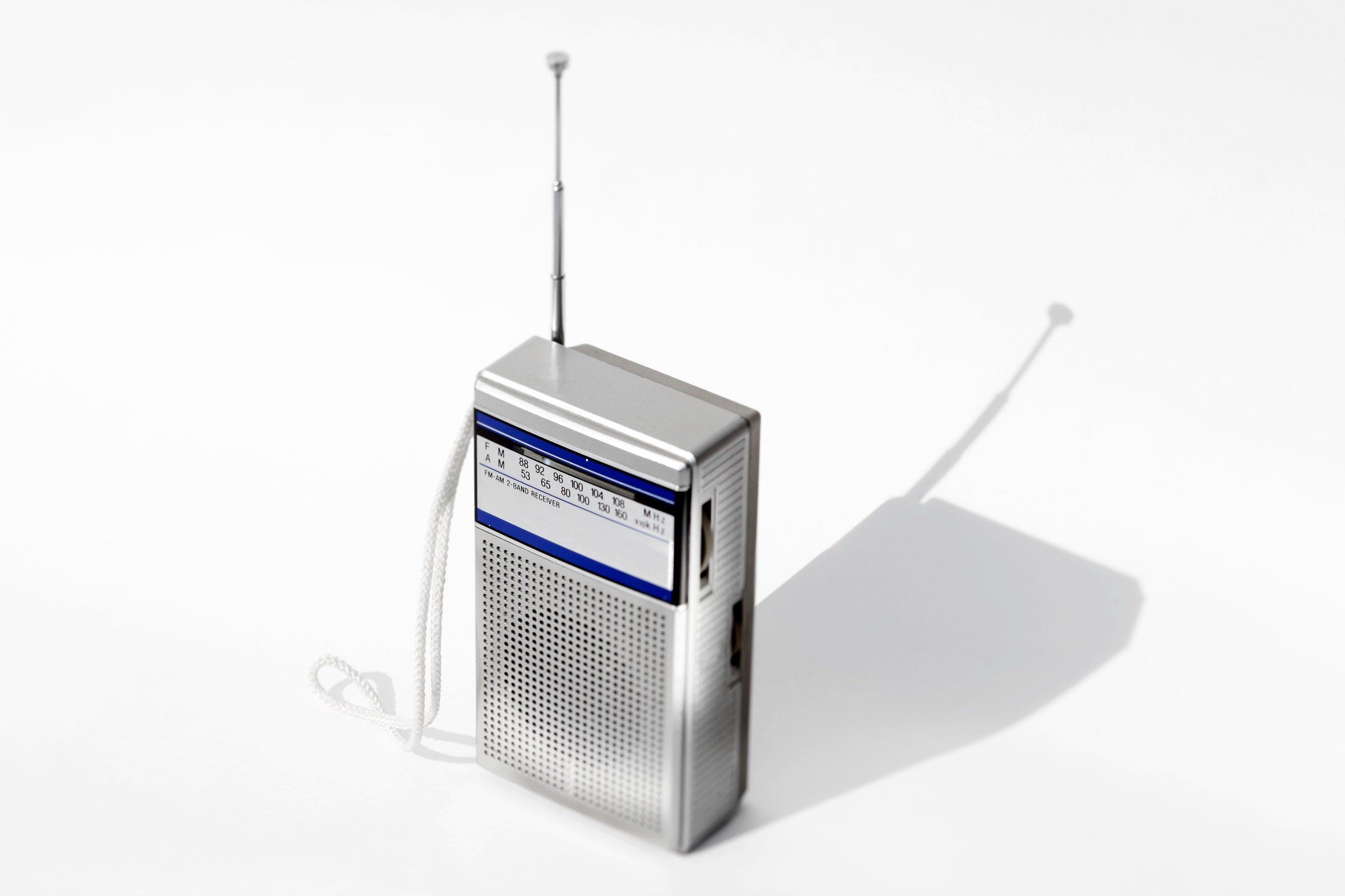 small silver portable radio on gray background