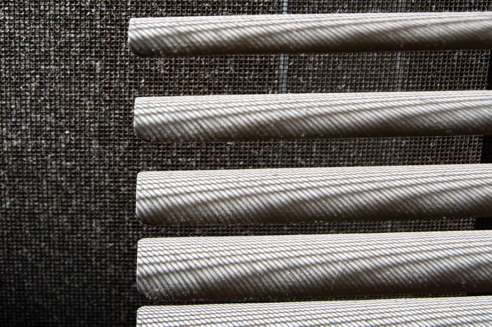 Dust blinds inside a window, Dust and Dirty mosquito wire screen window, Light & Shadow shot, Close up and macro shot, Selective focus