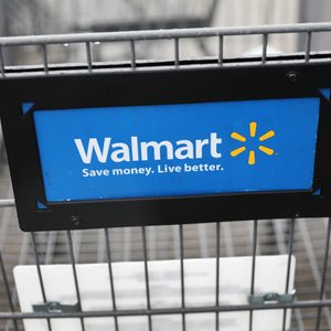 Shopping cart displaying Walmart's logo and slogan, 