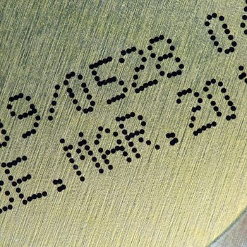 Metallic surface displays printed text: "L09/0528 042 BBE. MAR. 2014," likely indicating a production or expiration date.