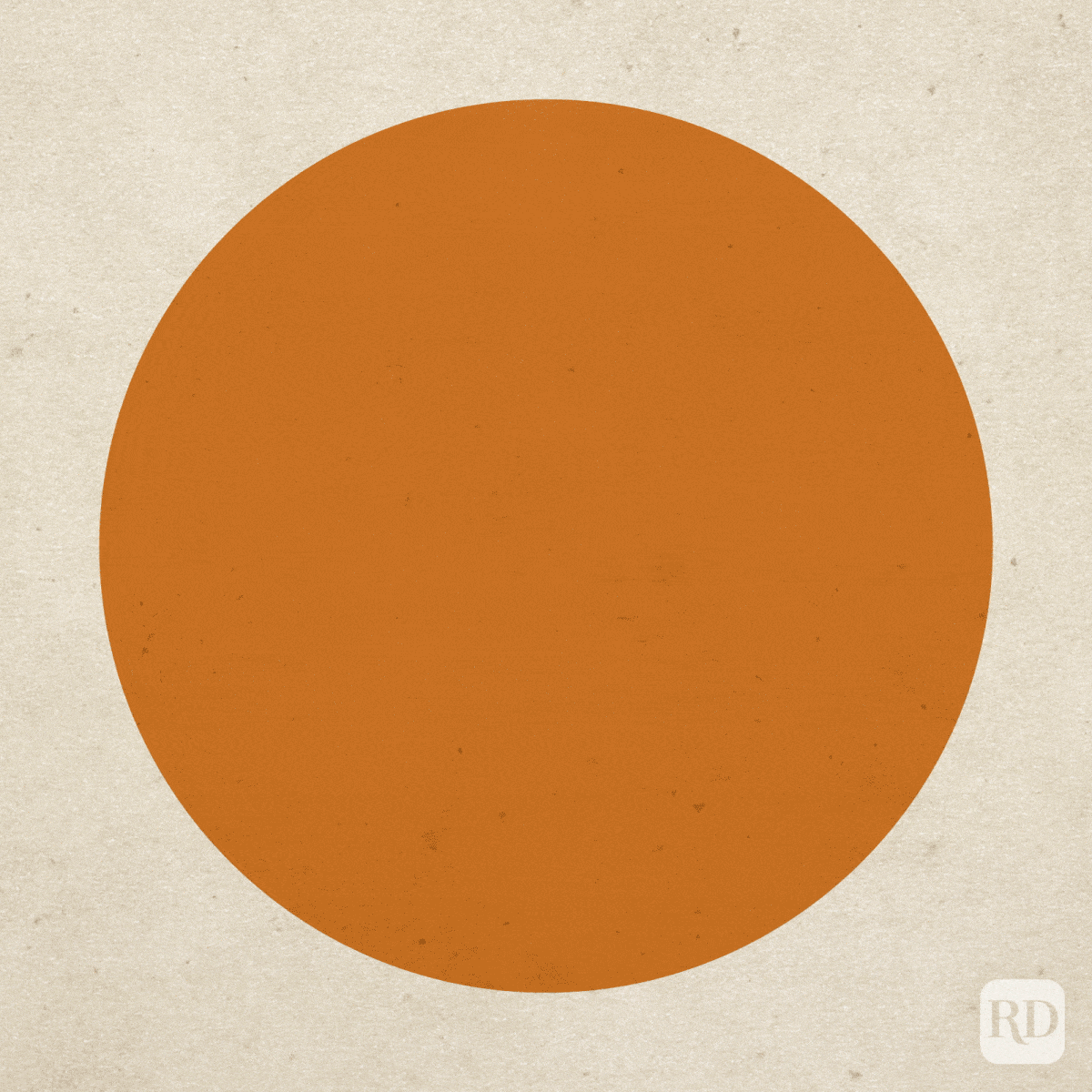 An orange circle remains static against a textured beige background.