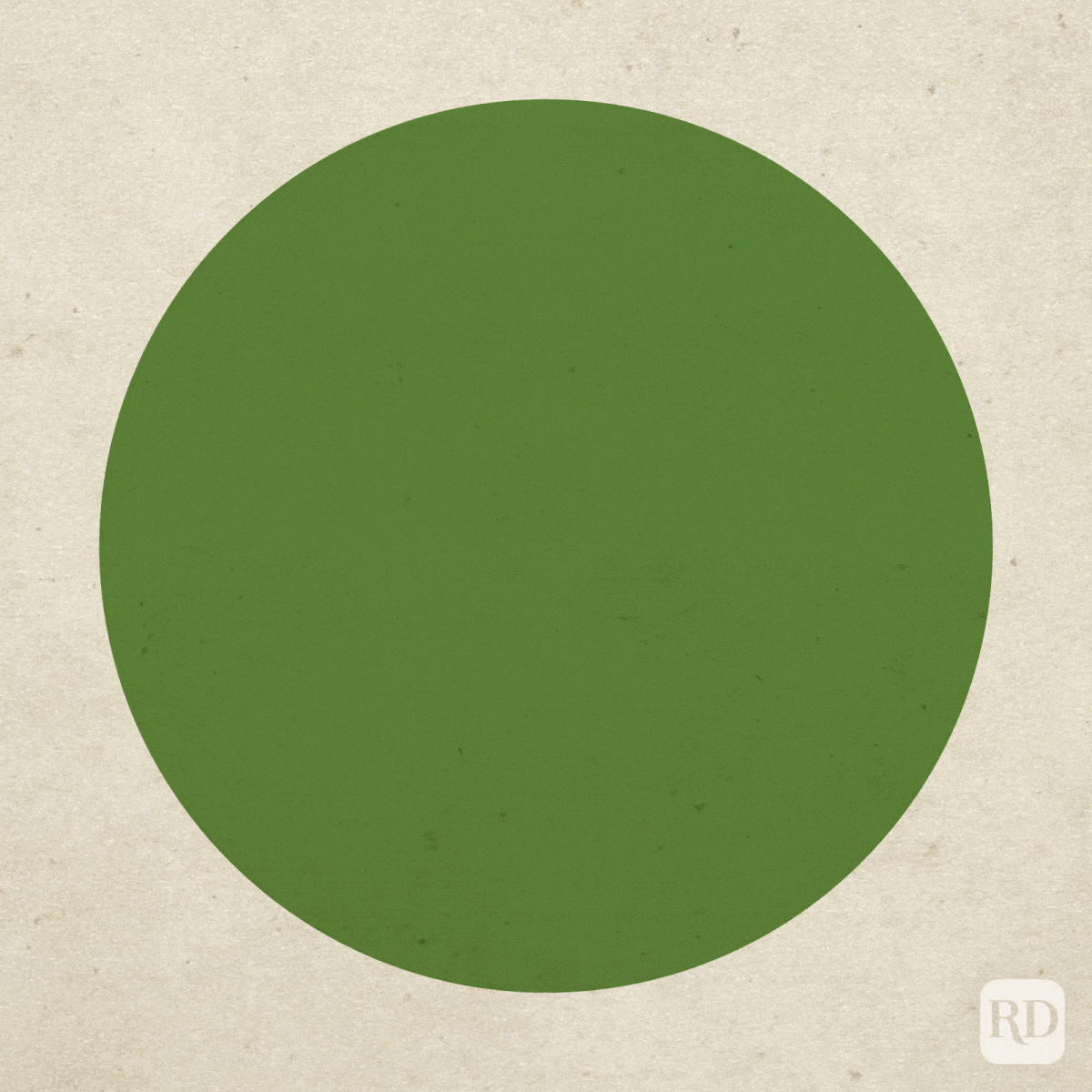 A large green circle sits still on a textured beige background, creating a simple, flat composition.