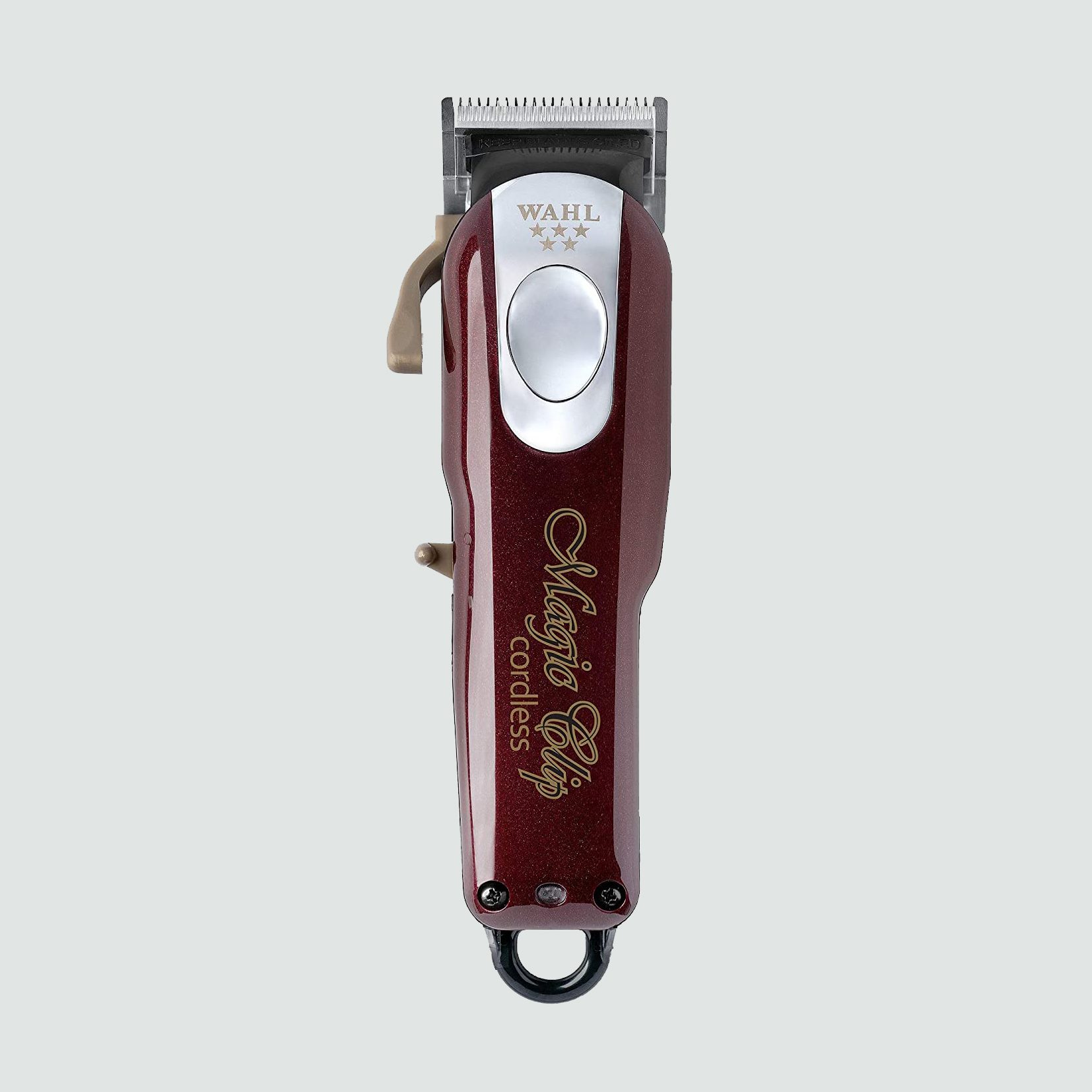 Hair clipper resting vertically, featuring a maroon body with silver accents, labeled "Wahl" and "Magic Clip cordless," set against a plain background.