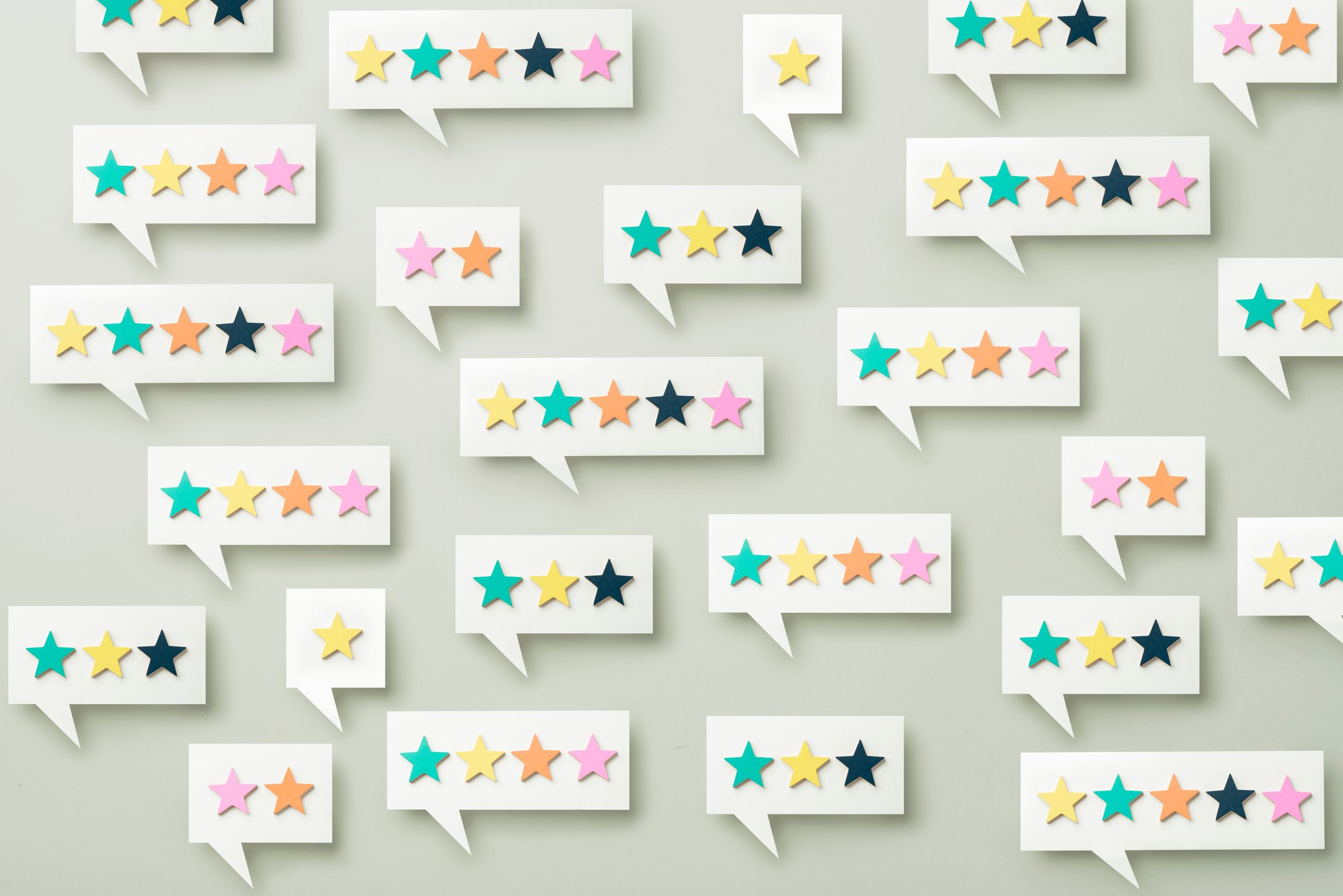 Speech bubbles display colorful stars in various arrangements, set against a pale background.
