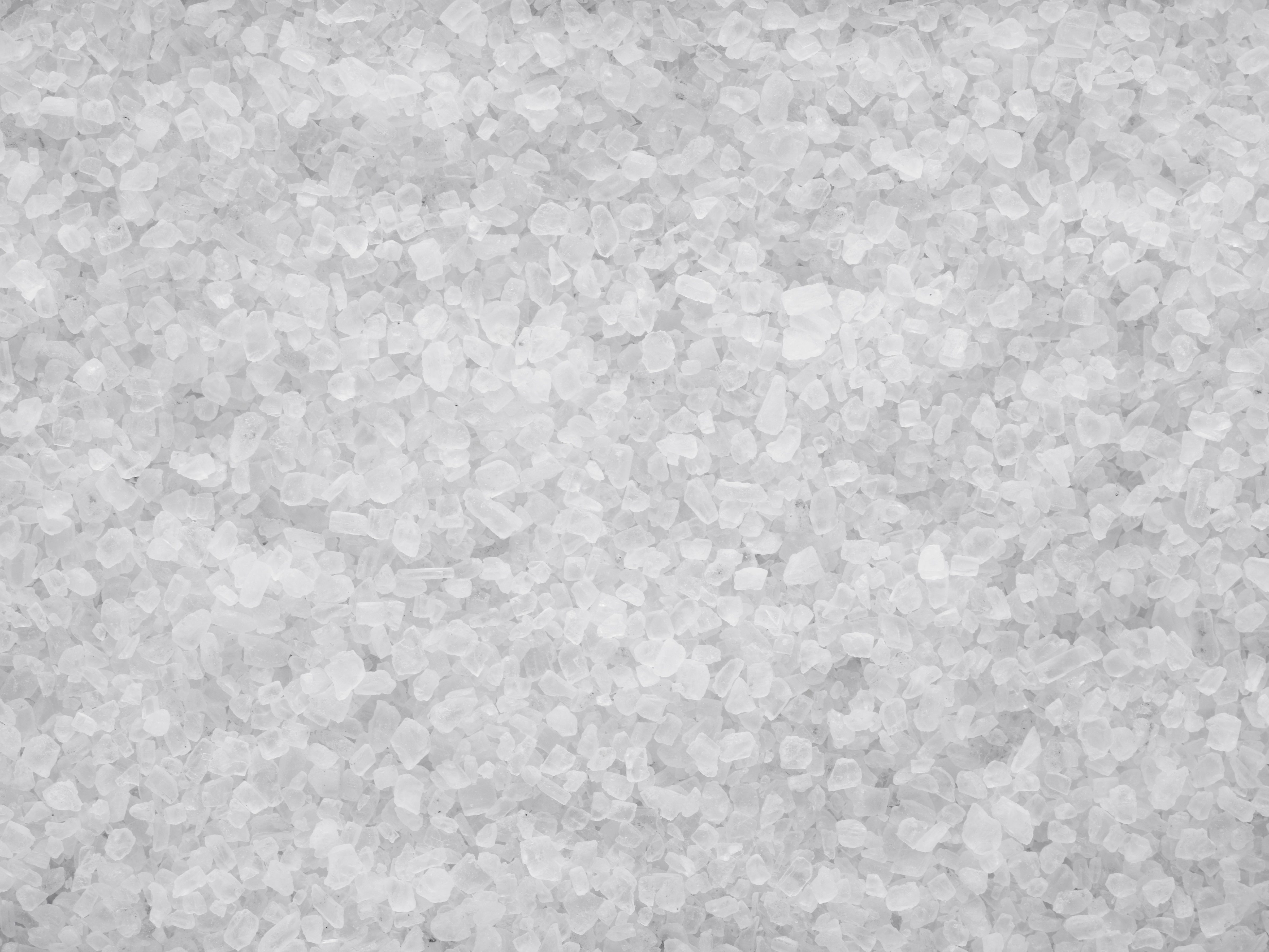 White salt crystals scattered densely, forming a textured surface. No additional context or objects are visible.