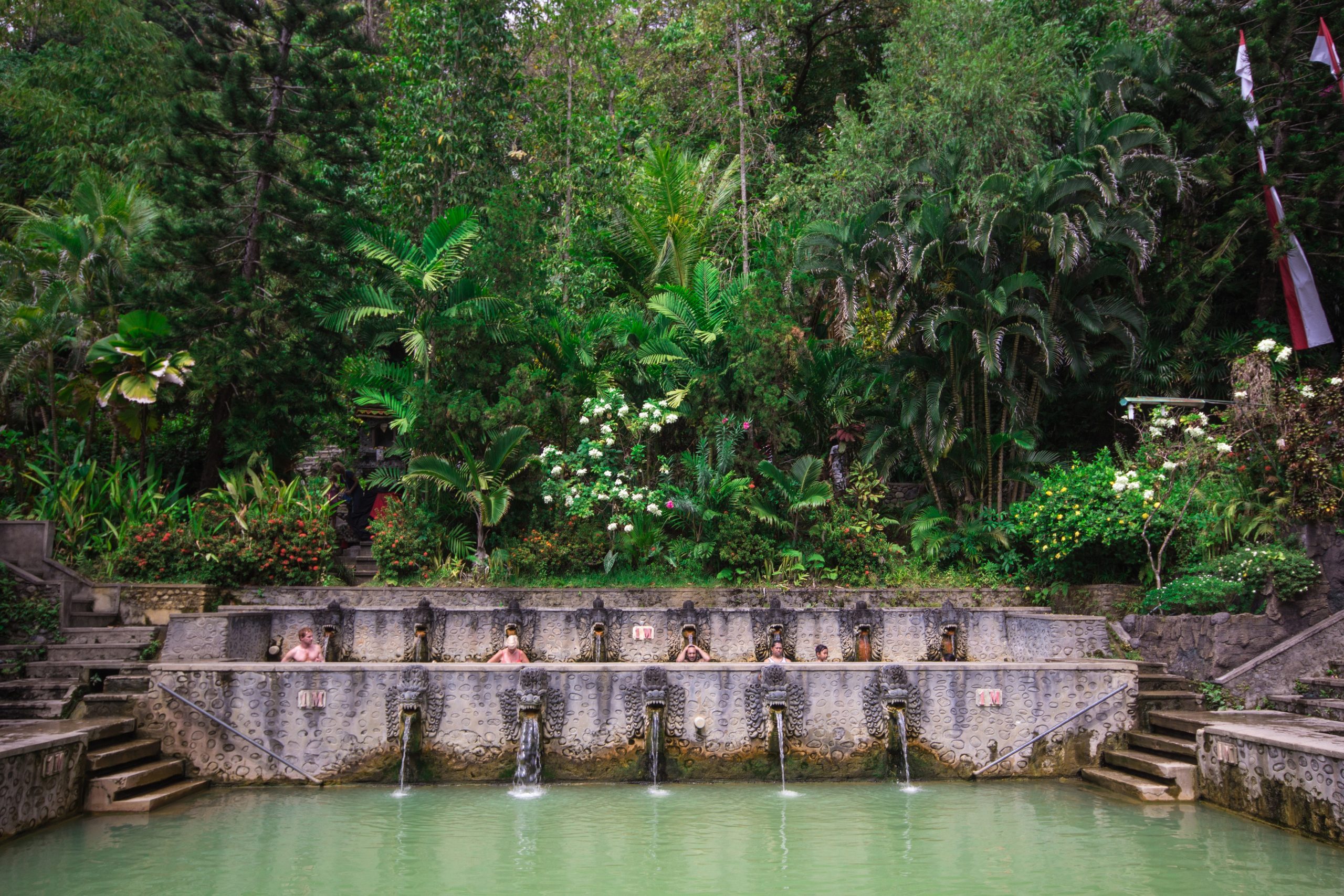 People take a bath in thermal Banjar Tega hot springs. Bali. Indonesia. Southeast Asia. Asia.