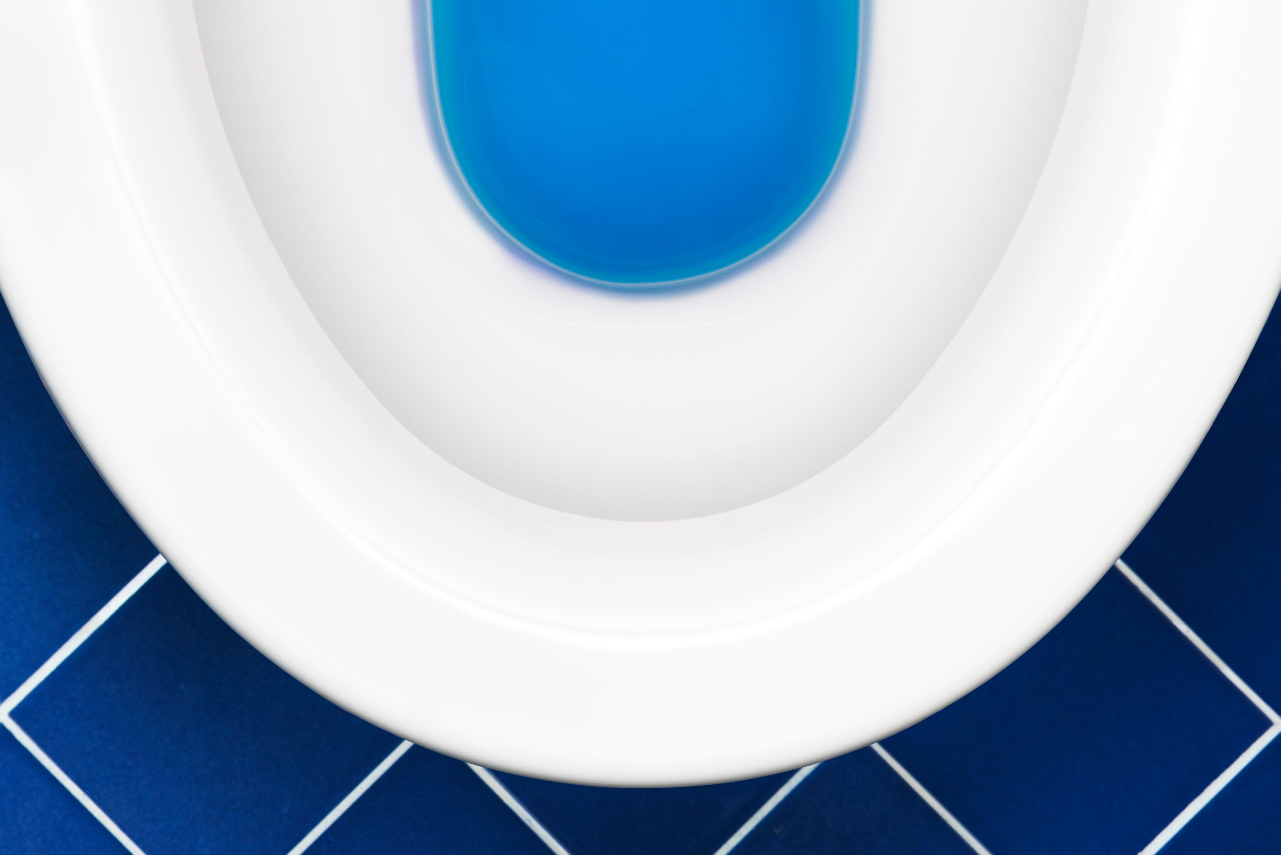 Toilet on blue tile