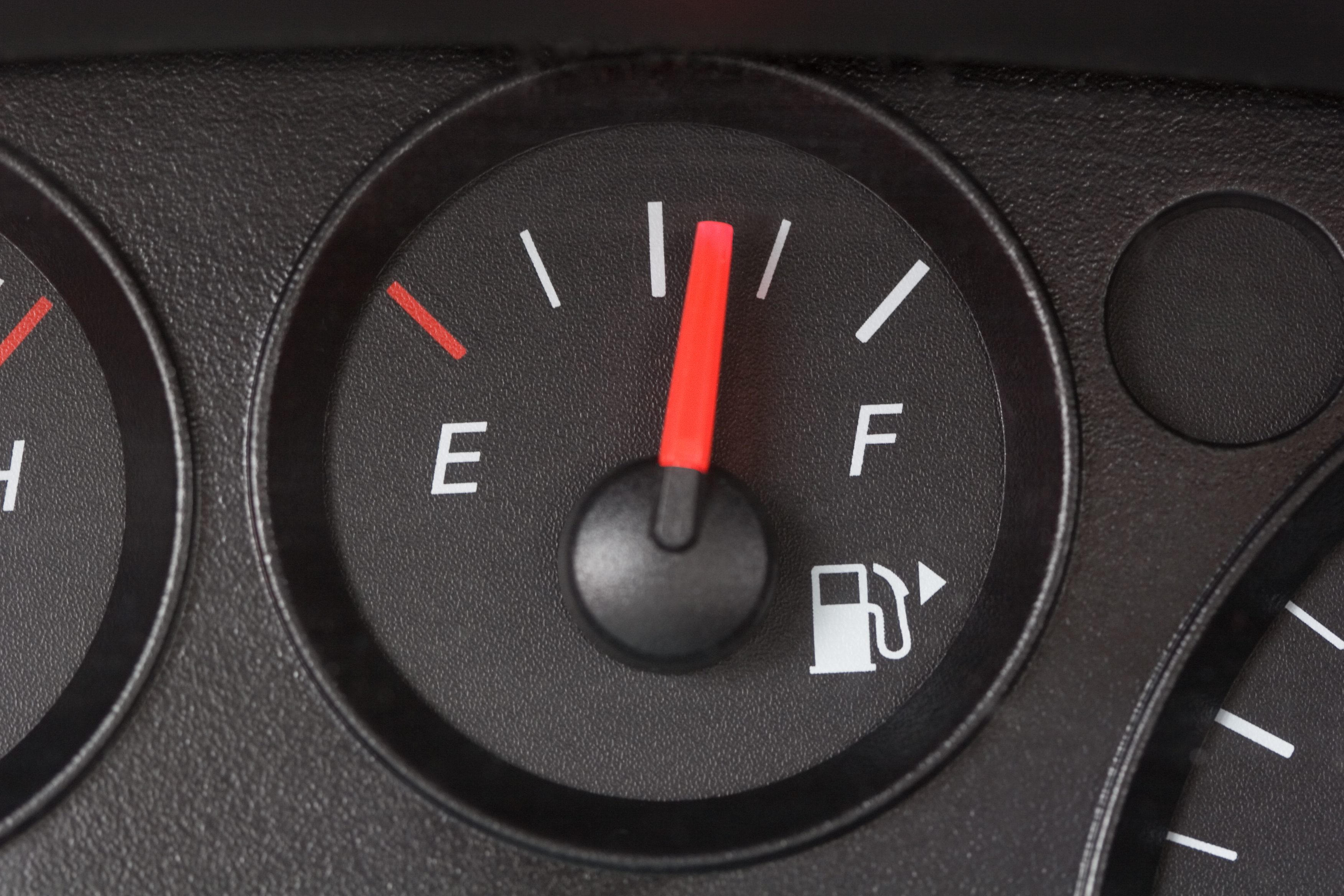 Black Fuel Gauge with Red Marker Over Half Full