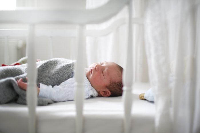 A new born sleeping in his cradle