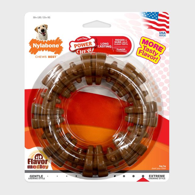 Brown chew toy sits in packaging, featuring text: 