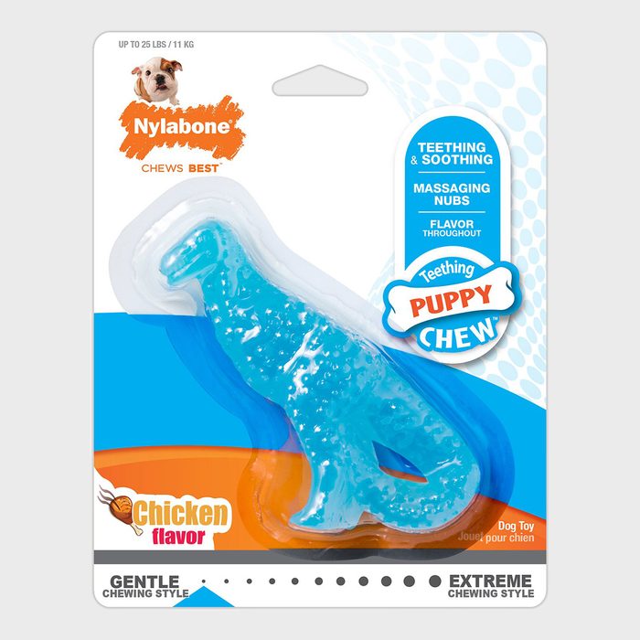 A blue teething toy shaped like a dinosaur is enclosed in packaging; labeled 