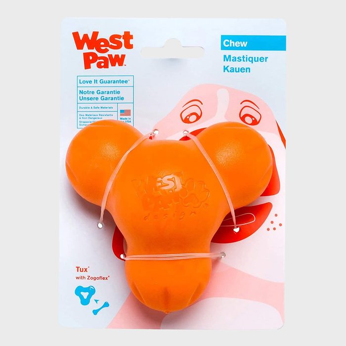 Orange dog toy displayed on packaging, secured with rubber bands. Packaging text includes 