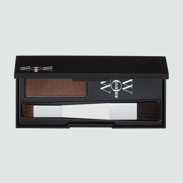Compact kit contains brown powder and brush arranged inside a black rectangular case, designed for cosmetic touch-ups. 