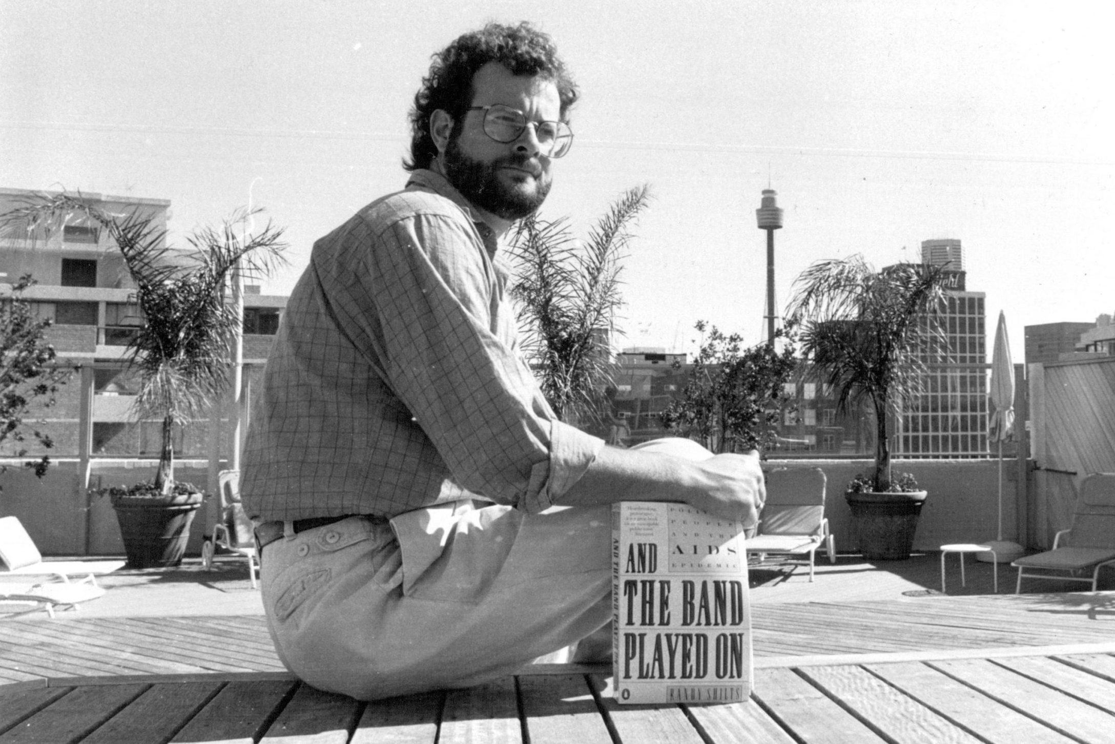 Gay Author Randy Shilts with his book an Aids & The Band Played On.