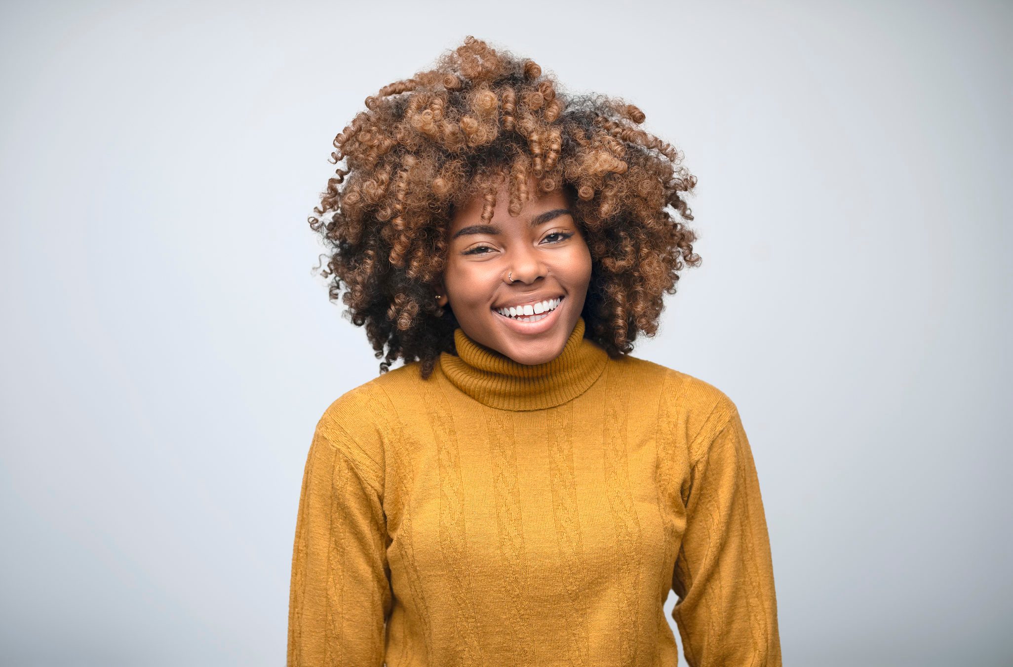 Portrait of cheerful female owner with curly hair
