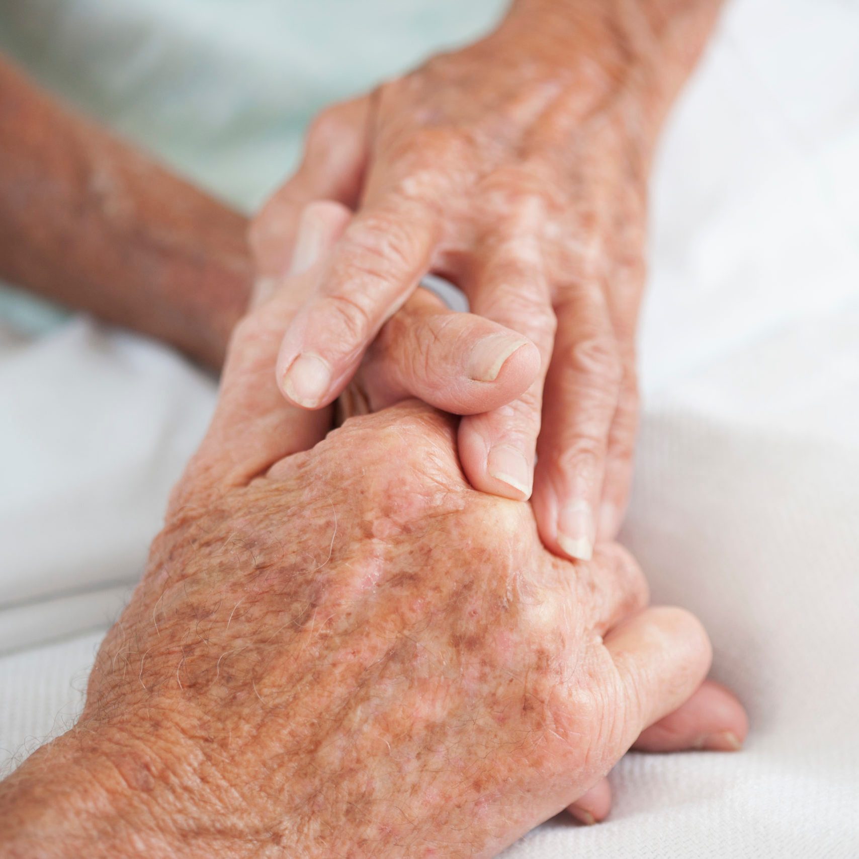 Husband comforting wife in hospital bed