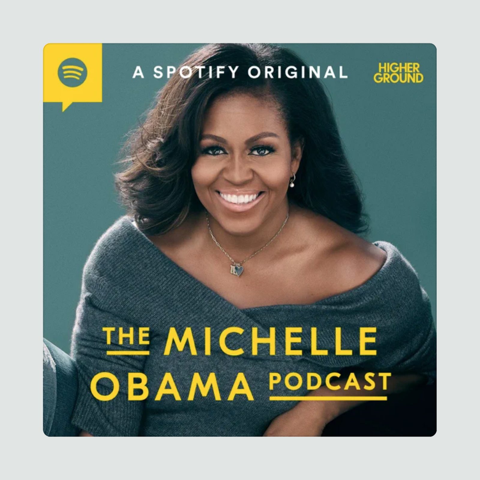 Smiling woman sits relaxed, wearing gray top, against a teal background; text reads "THE MICHELLE OBAMA PODCAST" and "A SPOTIFY ORIGINAL HIGHER GROUND."