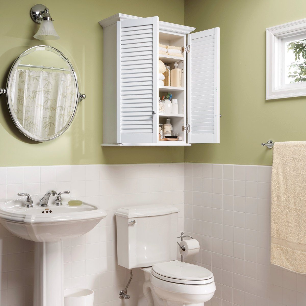 Bathroom cabinet with open doors showing shelves filled with toiletries; set in a bathroom with sink, mirror, shower curtain, and toilet.