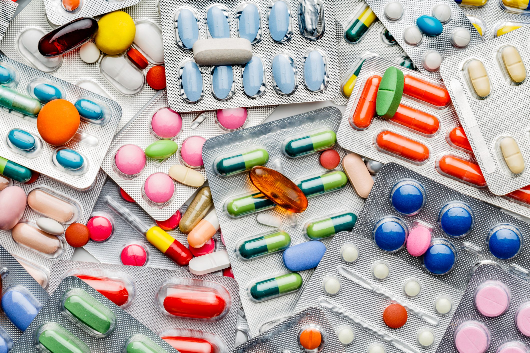 Background of a large group of assorted capsules, pills and blisters
