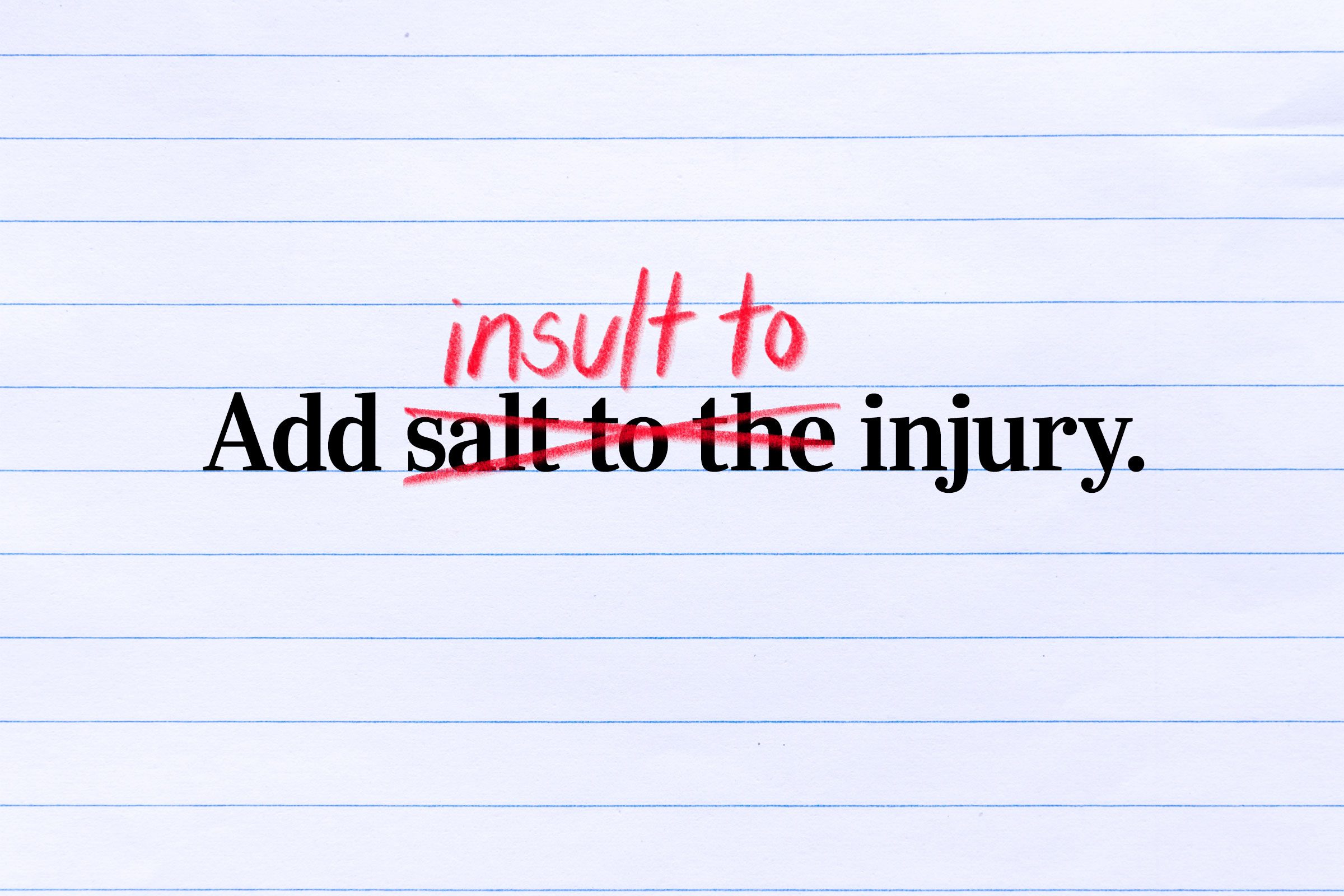Text correction on lined paper reads: "Add insult to the injury," with "insult" changed to "salt."