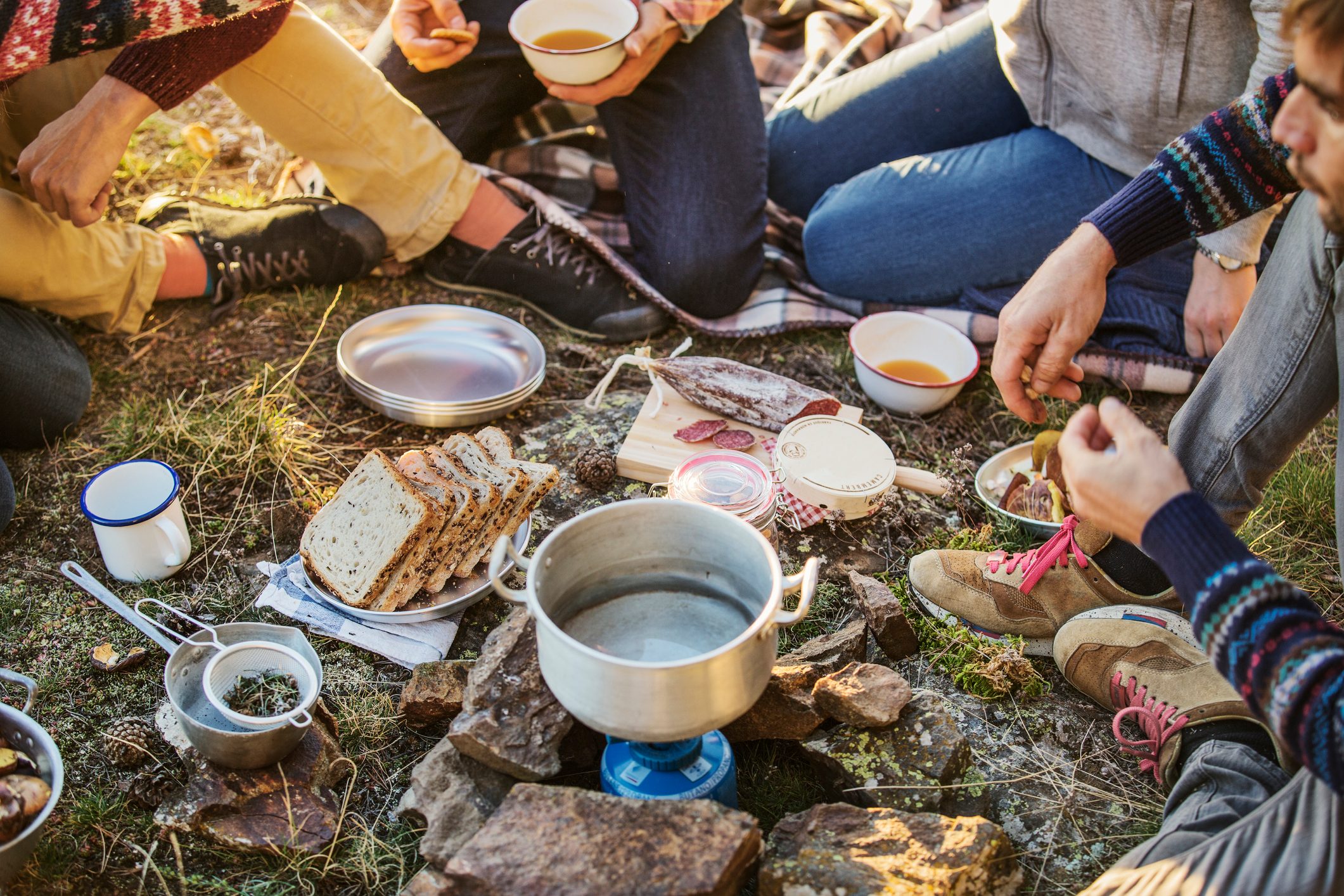 Friends preparing breakfast at campsite