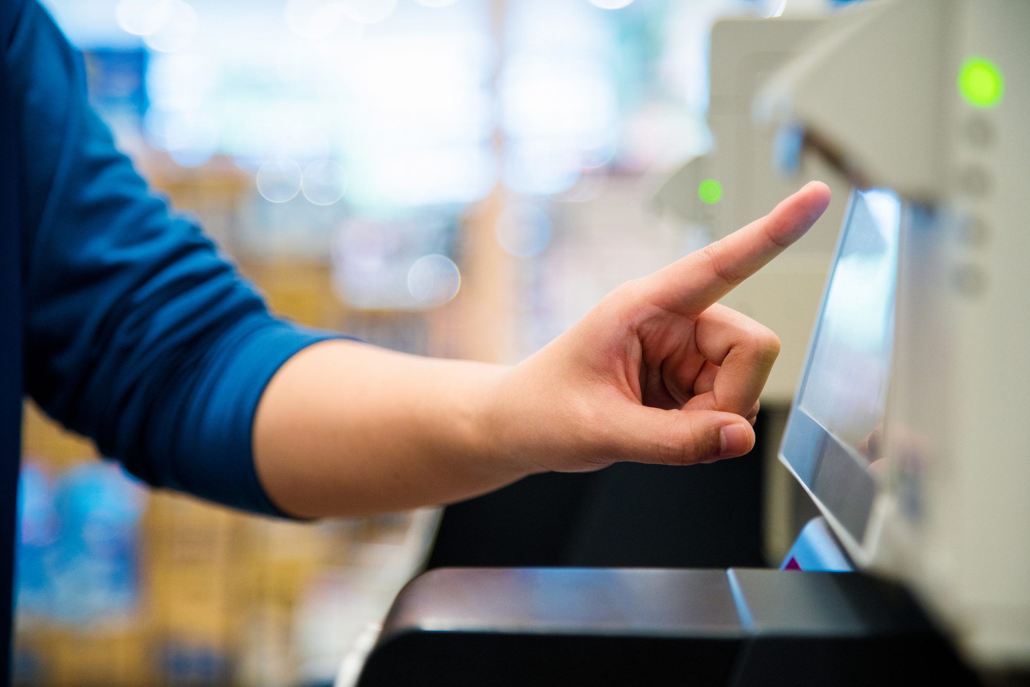 Close up of a woman using a self checkout machine
