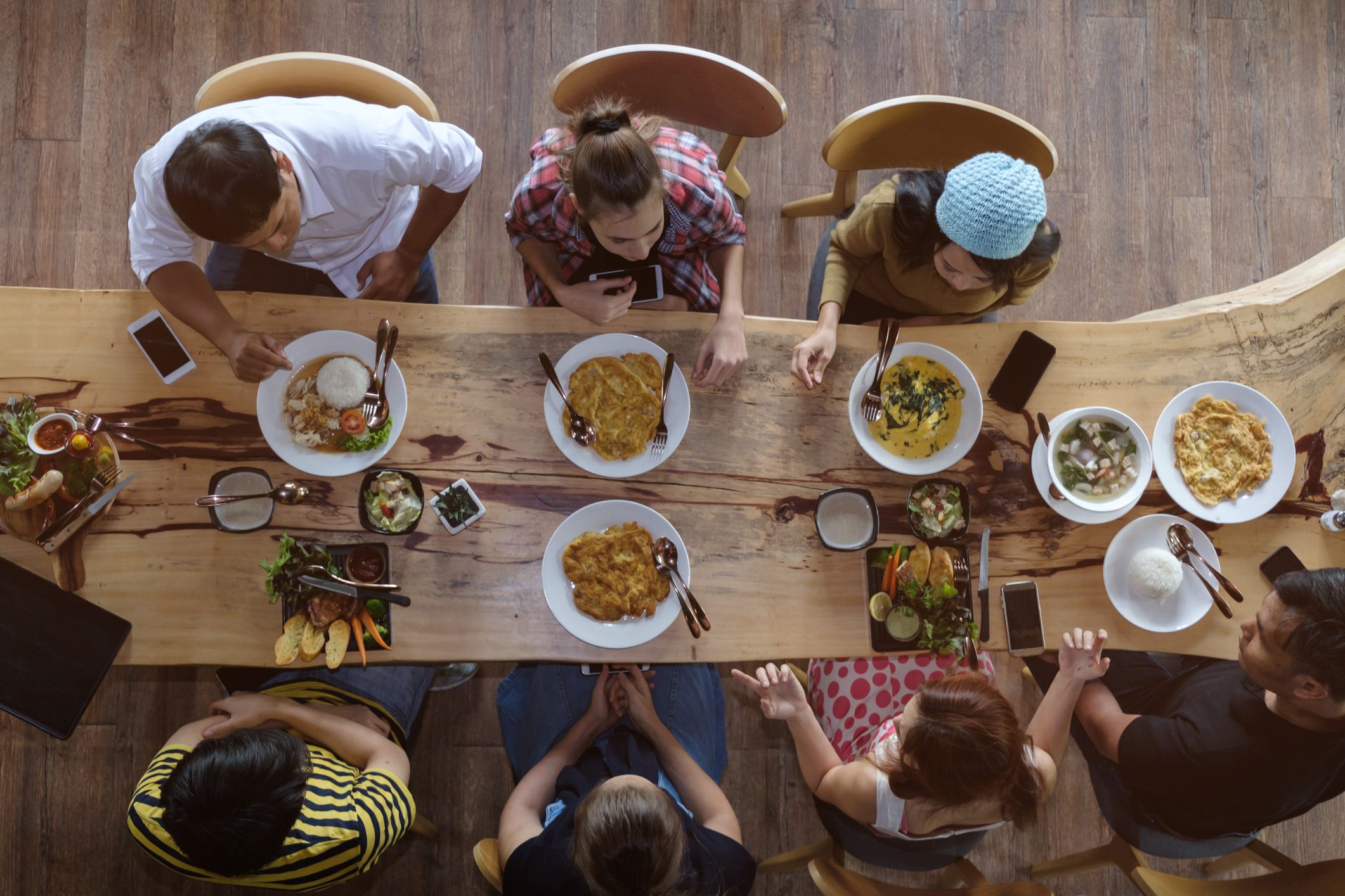 Directly Above Shot Of Friends Having Food On Restaurant Table