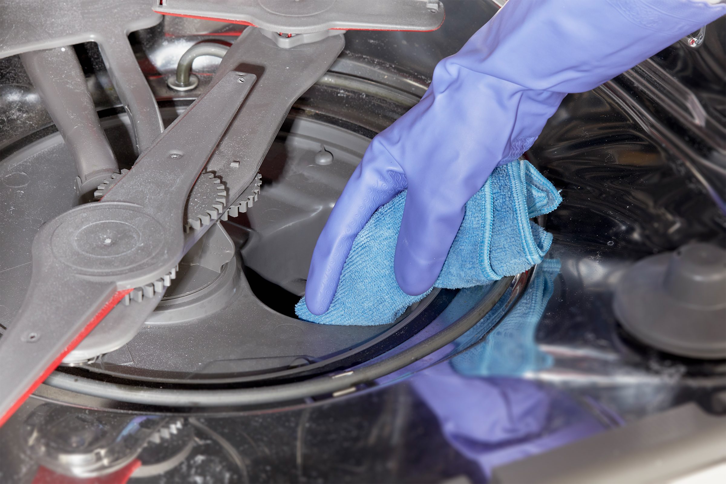 Cleaning Inside Of Dishwasher with a microfiber cloth