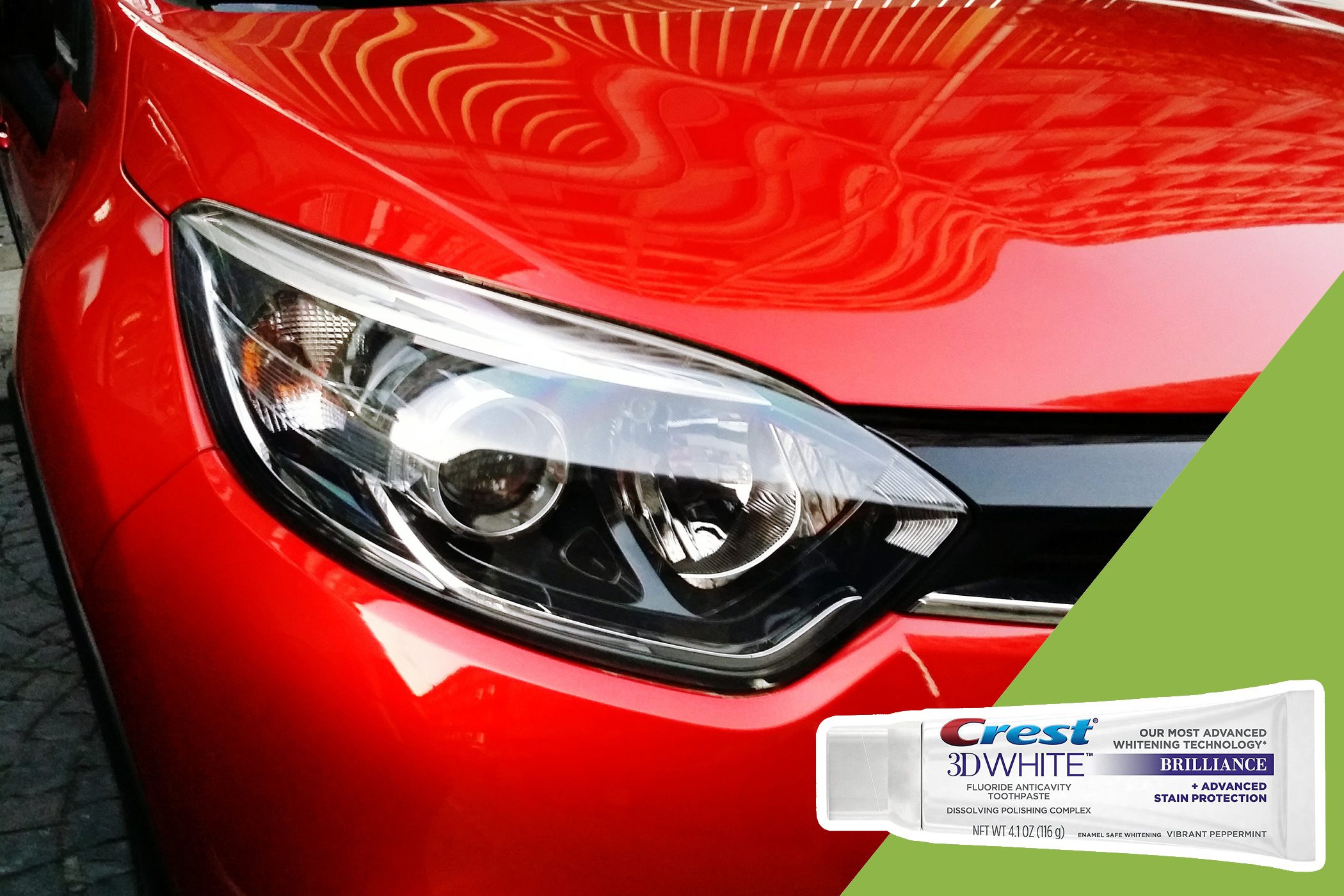 Car headlight reflects architectural patterns, illuminated by bright red paint under natural lighting. A Crest 3D White toothpaste tube is displayed on a green background.
