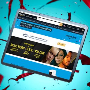 Tablet displays Amazon Prime Day deals page, featuring a Prime Day show with artists. Background is blue with red ribbons.