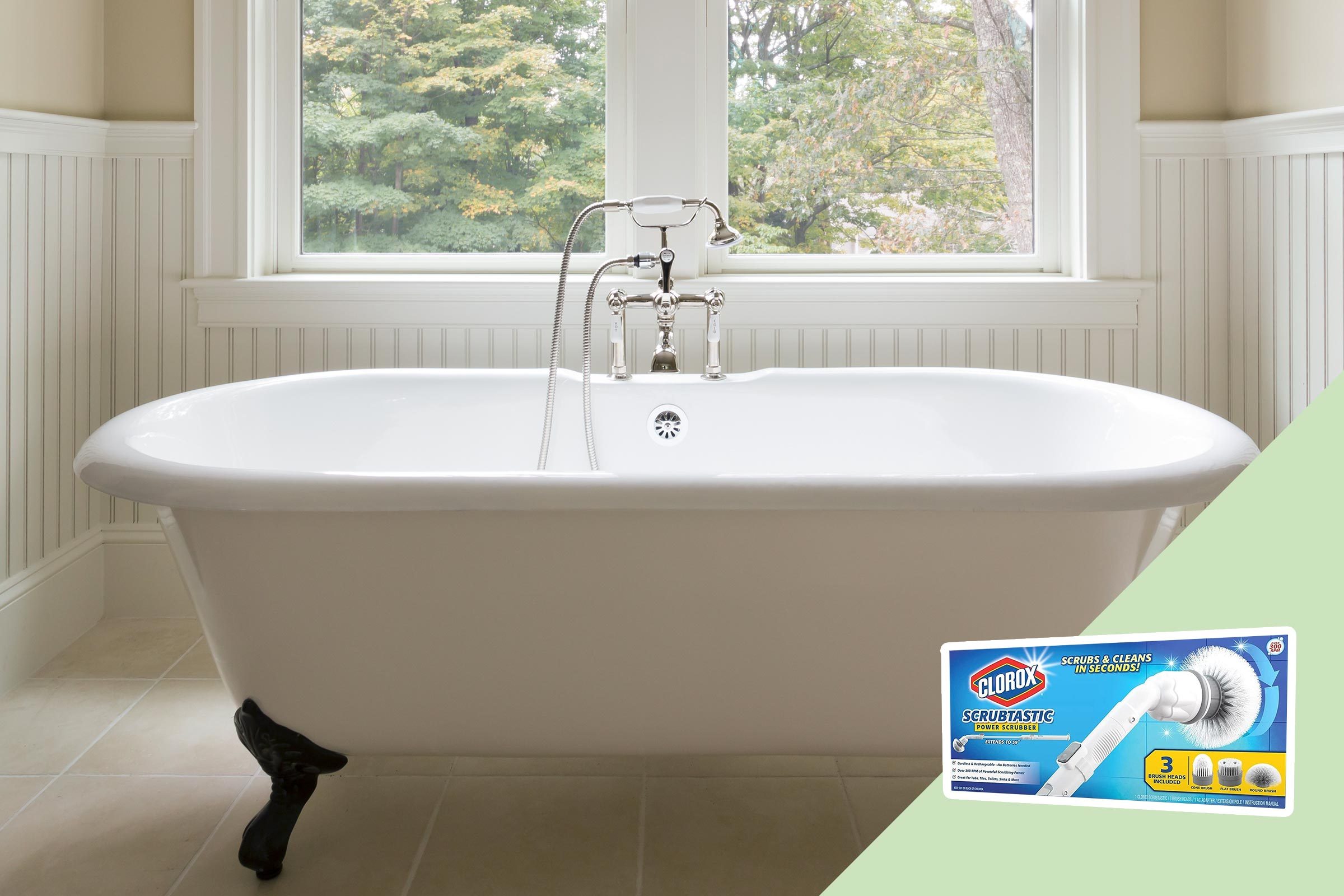 Bathtub stands in a light bathroom with paneling beneath a large window. Box of Clorox Scrubtastic power scrubber on the floor.