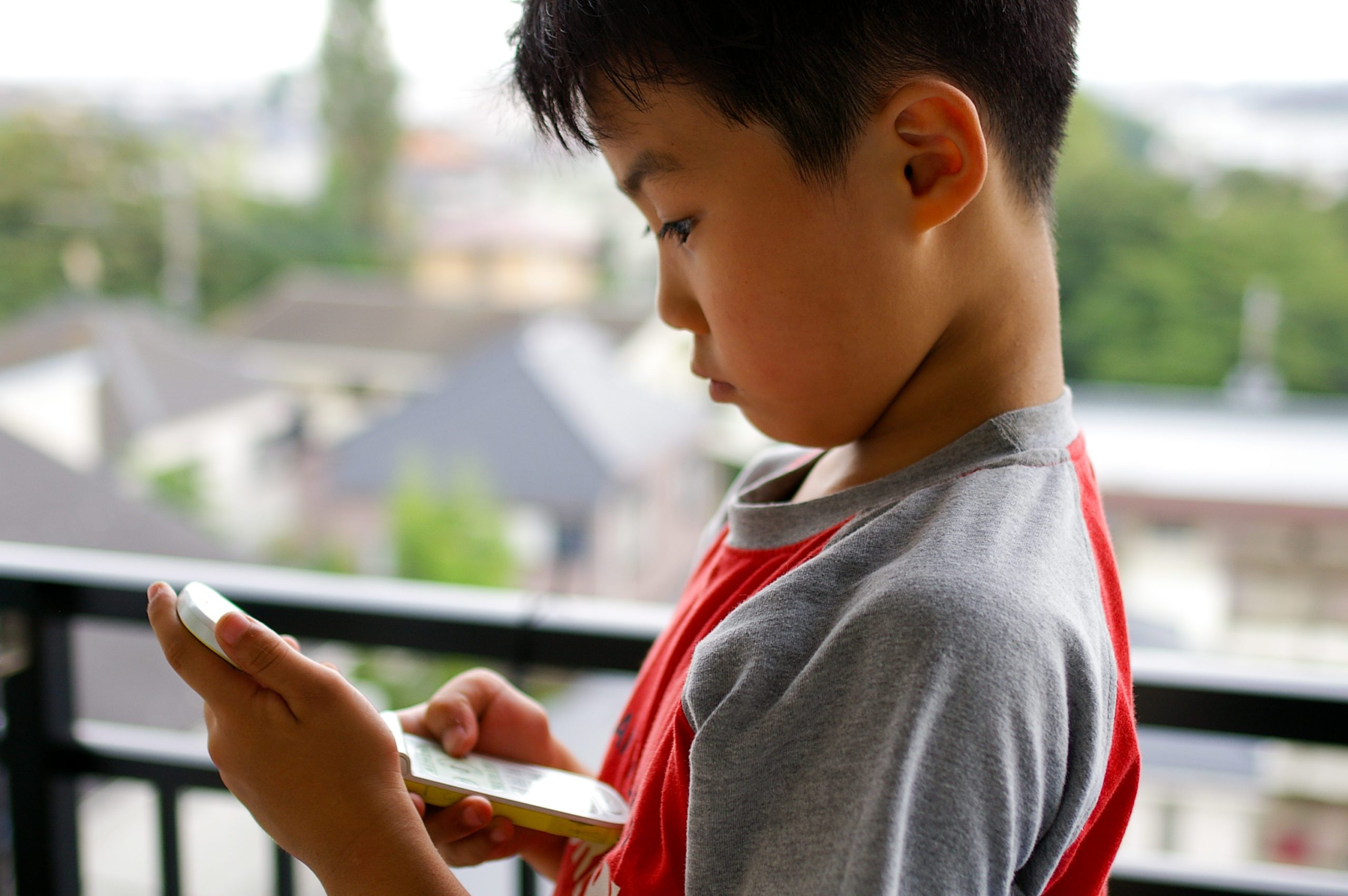 A boy using a cell phone