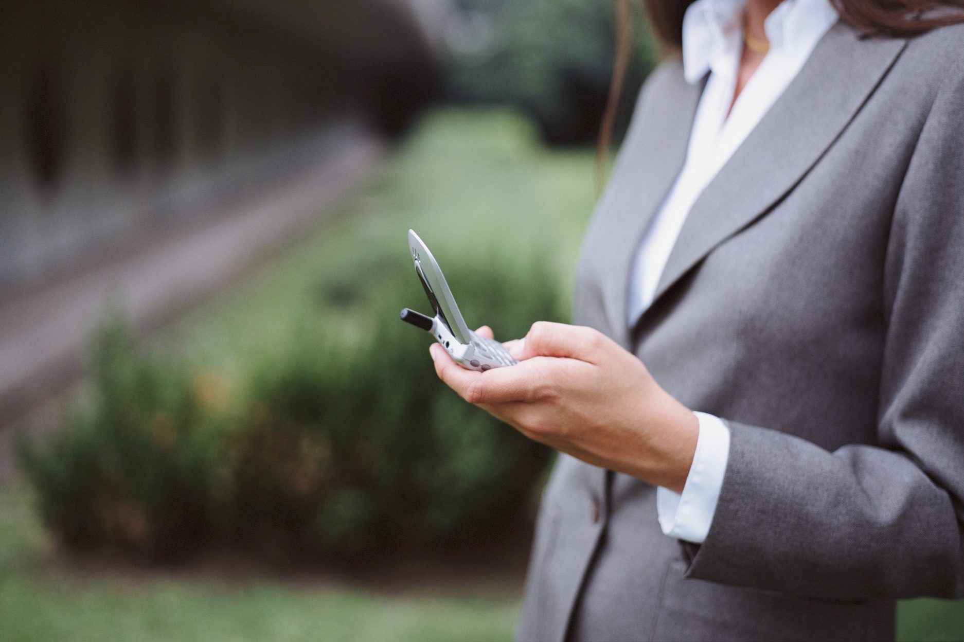 Young woman dialing cell phone (selective focus)