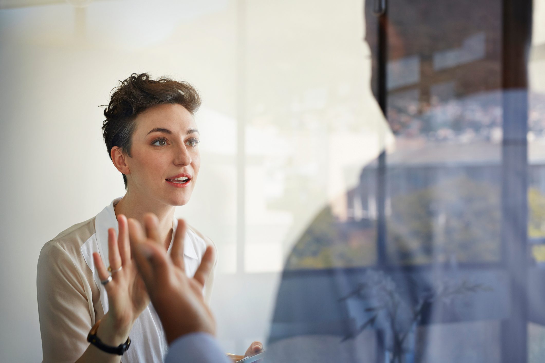 Businesswoman having discussion with male coworker
